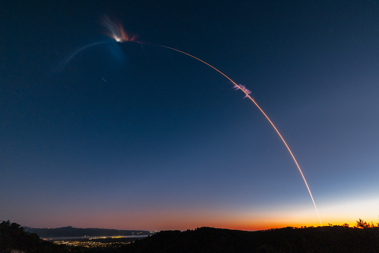 The launch of Firefly Aerospace Alpha FLTA005 appears as a pink arc across a twilight sky. Photo by Trevor Mahlmann / Firefly Aerospace.